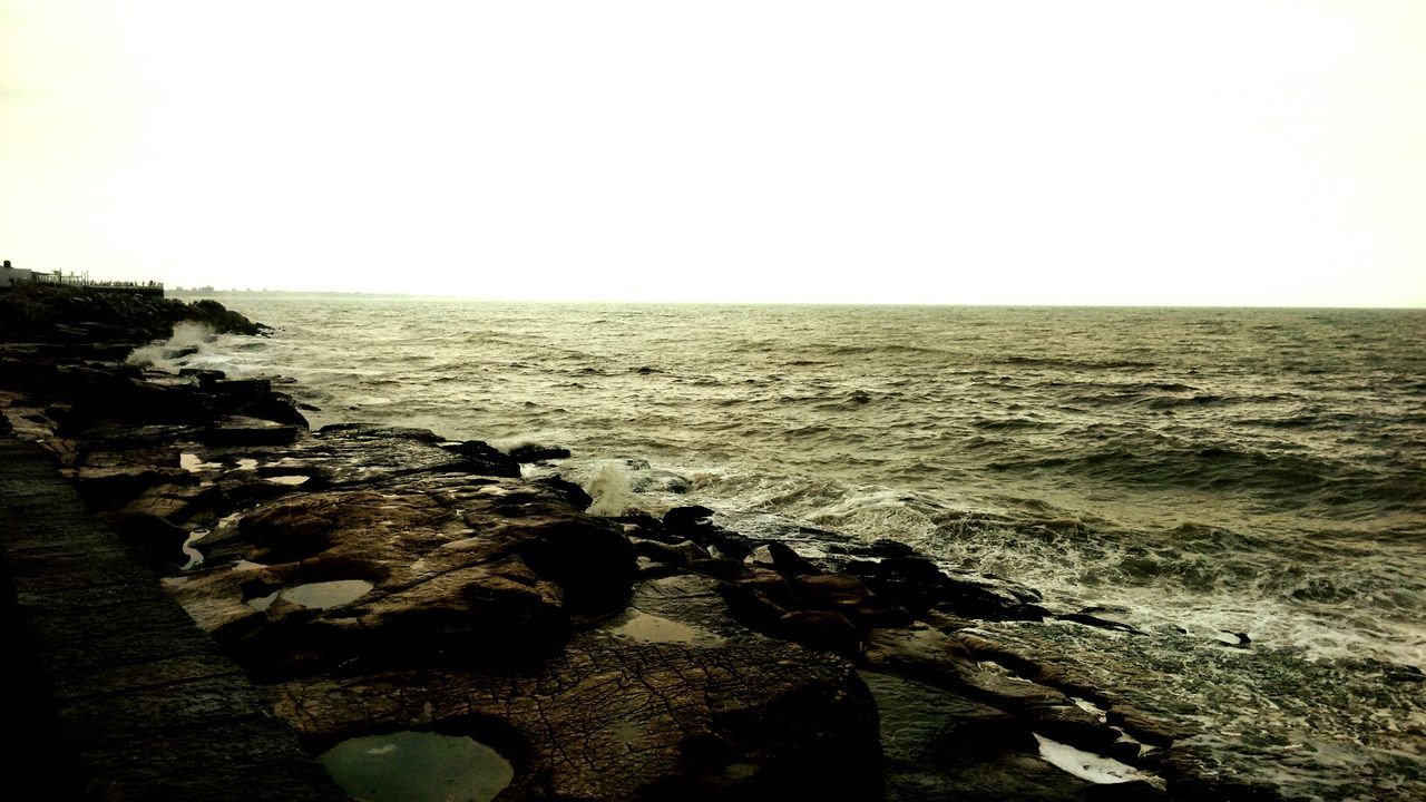 sea, water, horizon over water, clear sky, tranquil scene, tranquility, scenics, copy space, beauty in nature, nature, rock - object, beach, shore, idyllic, sky, rock, coastline, calm, outdoors, rippled