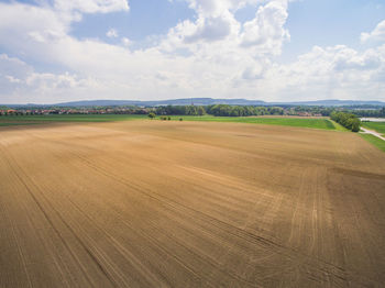 Scenic view of farm against sky