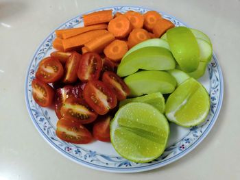 High angle view of fruits in plate on table