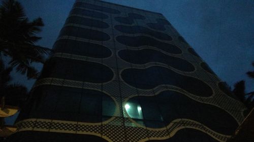 Low angle view of illuminated building against sky at night