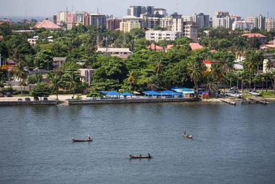 Boats in river with buildings in background