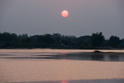 Scenic view of lake against sky at night