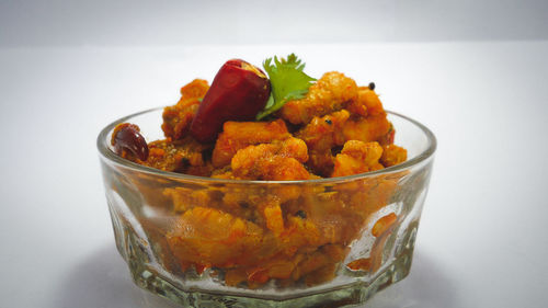 Close-up of strawberries in glass container on table