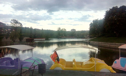 Panoramic view of swimming pool by lake against sky