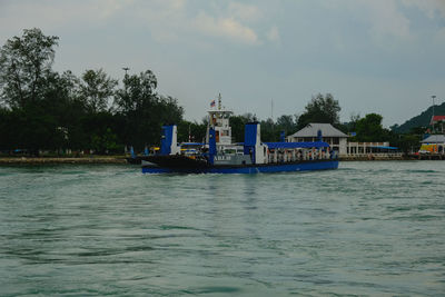 Scenic view of sea by building against sky