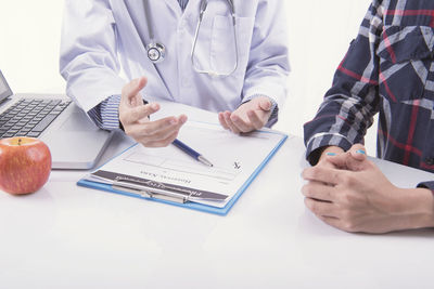 Midsection of man using laptop on table