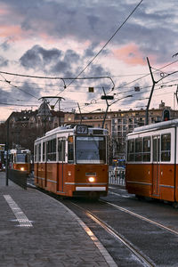 Railroad tracks in city against sky