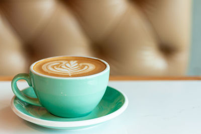 Close-up of coffee cup on table