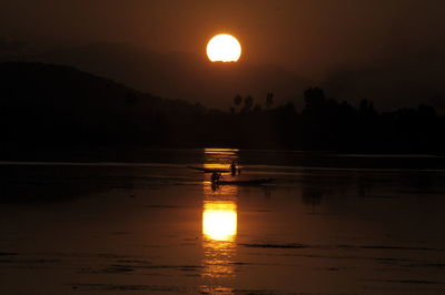 Scenic view of lake against sky during sunset