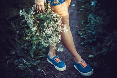 Close-up of woman holding flowers