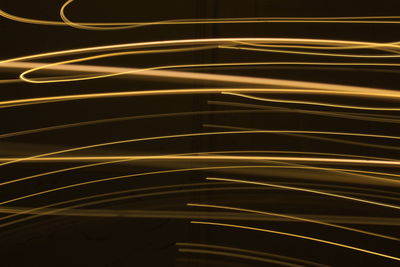 Abstract colorful light painting irregular lines on black background photo with long exposure.
