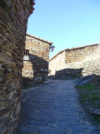 Low angle view of fort against clear blue sky