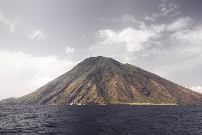 Scenic view of sea and mountains against sky