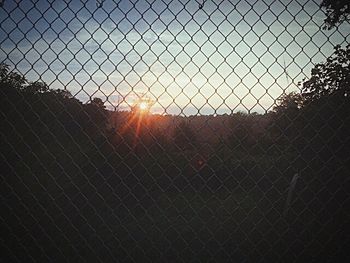 Sunset seen through chainlink fence