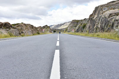 Surface level of empty road against mountain range