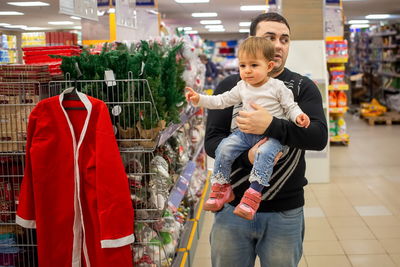 Full length of boy standing in store