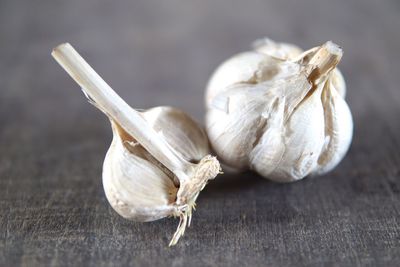 Close-up of garlic on wooden table