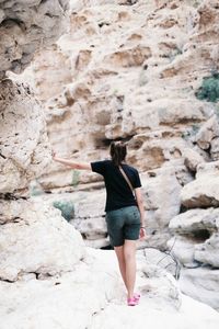 Woman standing on rock formation