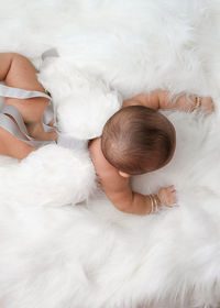 Cute baby in costume lying down on rug