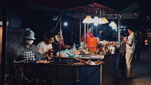 Group of people at market stall