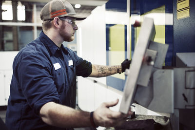 Manual worker using desktop computer in steel factory