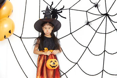 Full length portrait of girl standing on footpath during halloween