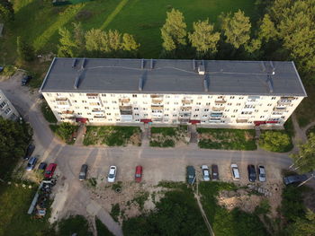 High angle view of vehicles on road along trees