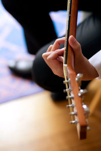 Cropped image of man playing guitar