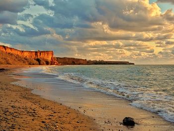 Scenic view of beach against sky during sunset