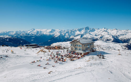 Panoramic view of snowcapped mountain against blue sky