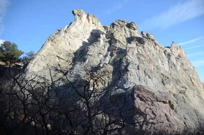 Low angle view of rock formation against sky