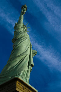 Low angle view of statue against blue sky