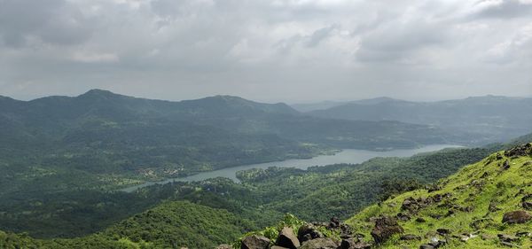 Scenic view of landscape and mountains against sky