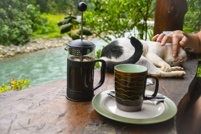 Man holding coffee cup on table