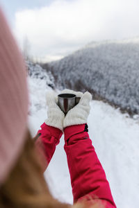 Midsection of person with snow on mountain