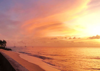 Scenic view of beach against sky during sunset