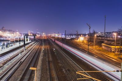 High angle view of light trails on railroad tracks at night