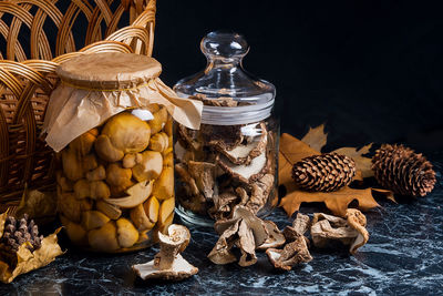 Close-up of mushrooms in glass jar on table
