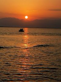 Scenic view of sea against orange sky