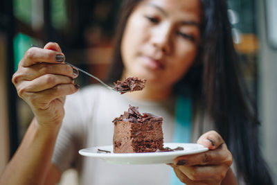 Close-up portrait of woman holding ice cream