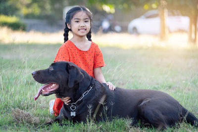 Young woman with dog on field