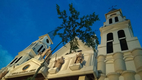 Low angle view of building against blue sky