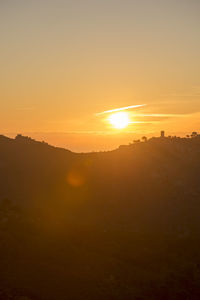 Scenic view of silhouette mountains against sky during sunset