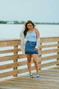 Portrait of a beautiful young woman against sea