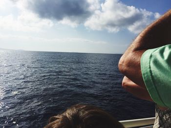 Close-up of man in sea against sky