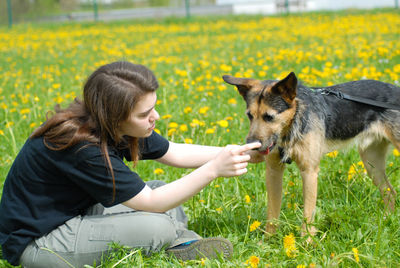 Side view of a young woman looking away on field