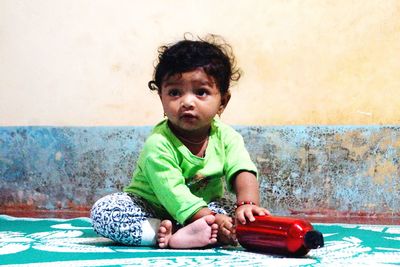 Portrait of boy playing with toy car