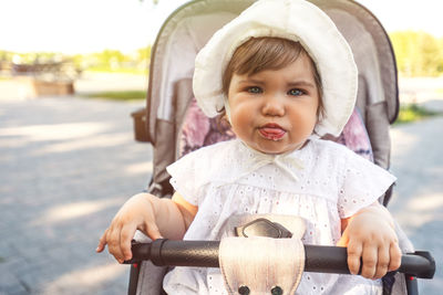 Portrait of cute baby girl in car