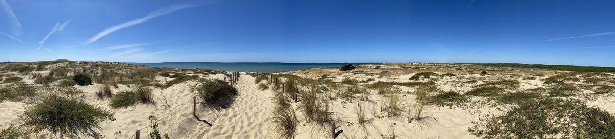 Panoramic view of land against blue sky