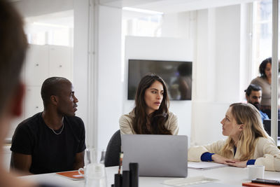 Group of business people discussing project in office